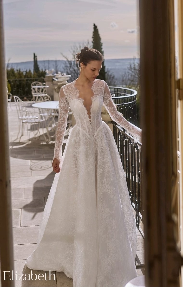A lace A-line gown with long sleeves and a deep V neckline