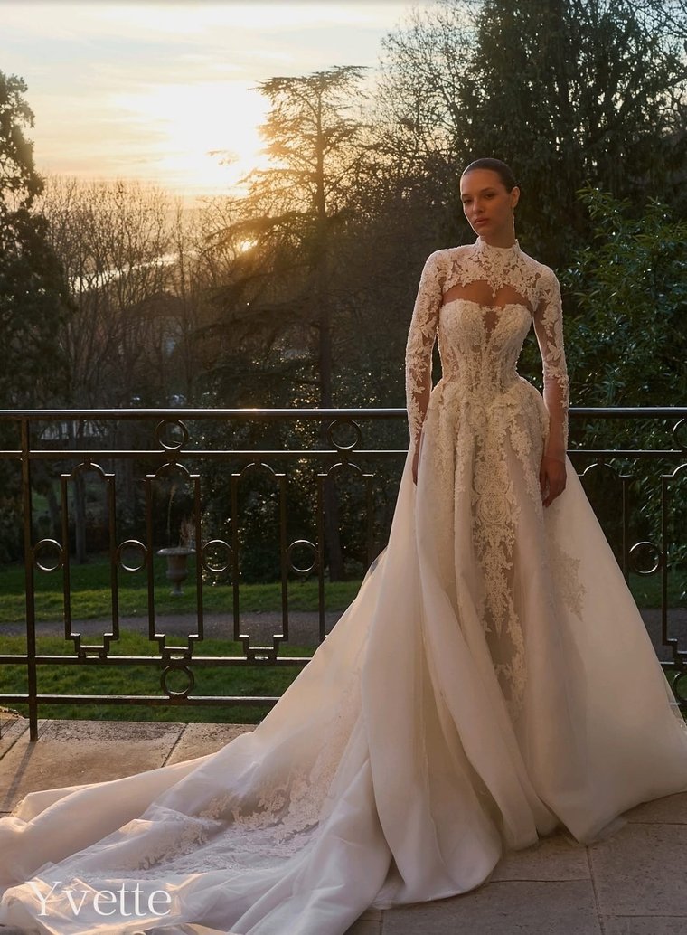 A beaded lace gown with a detachable organza overskirt