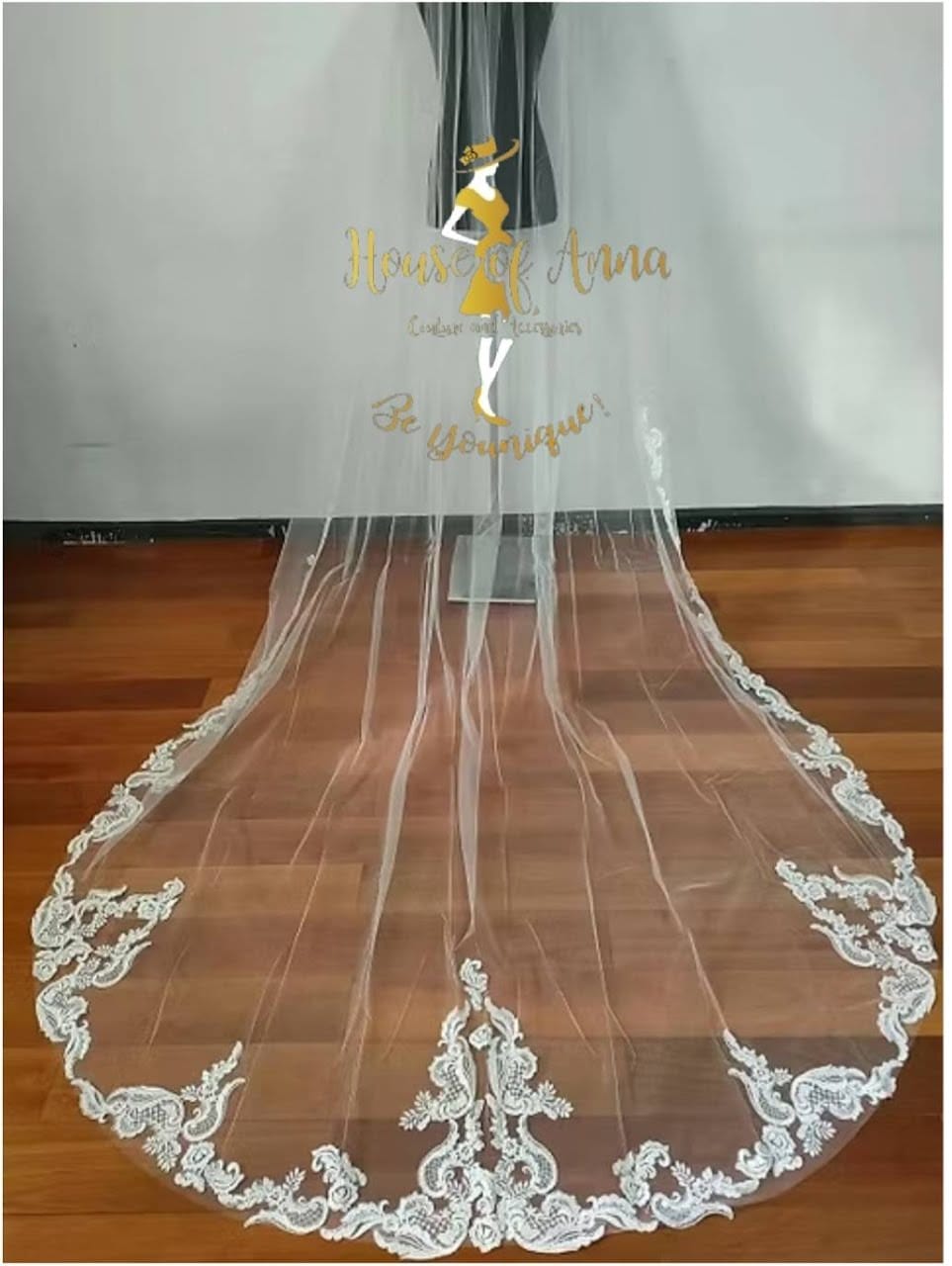 A tiered gown with an embroidered panel and a beaded cathedral veil
